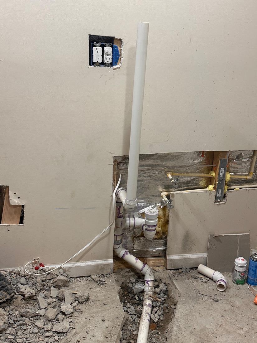 Plumbing and electrical rough-in behind the wall