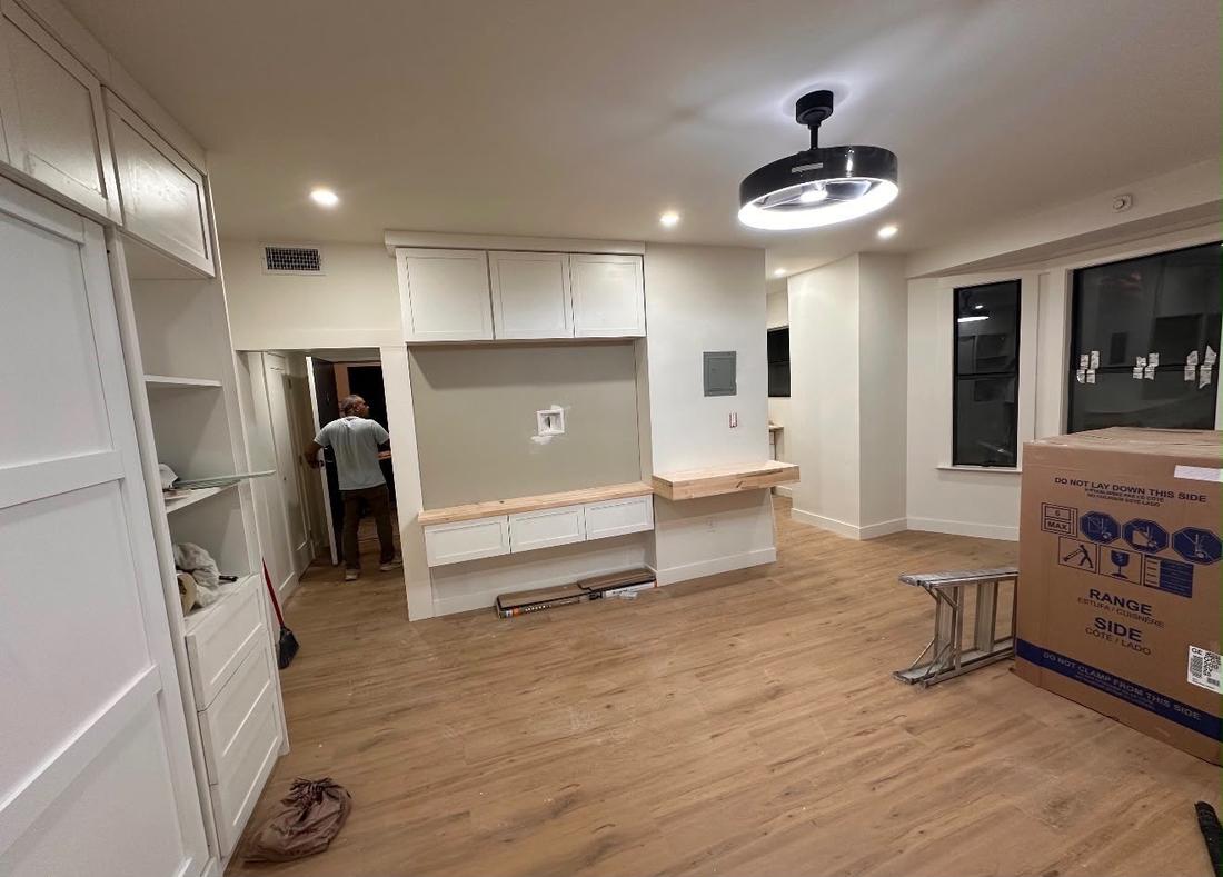Finished living space with built-in cabinetry and new flooring