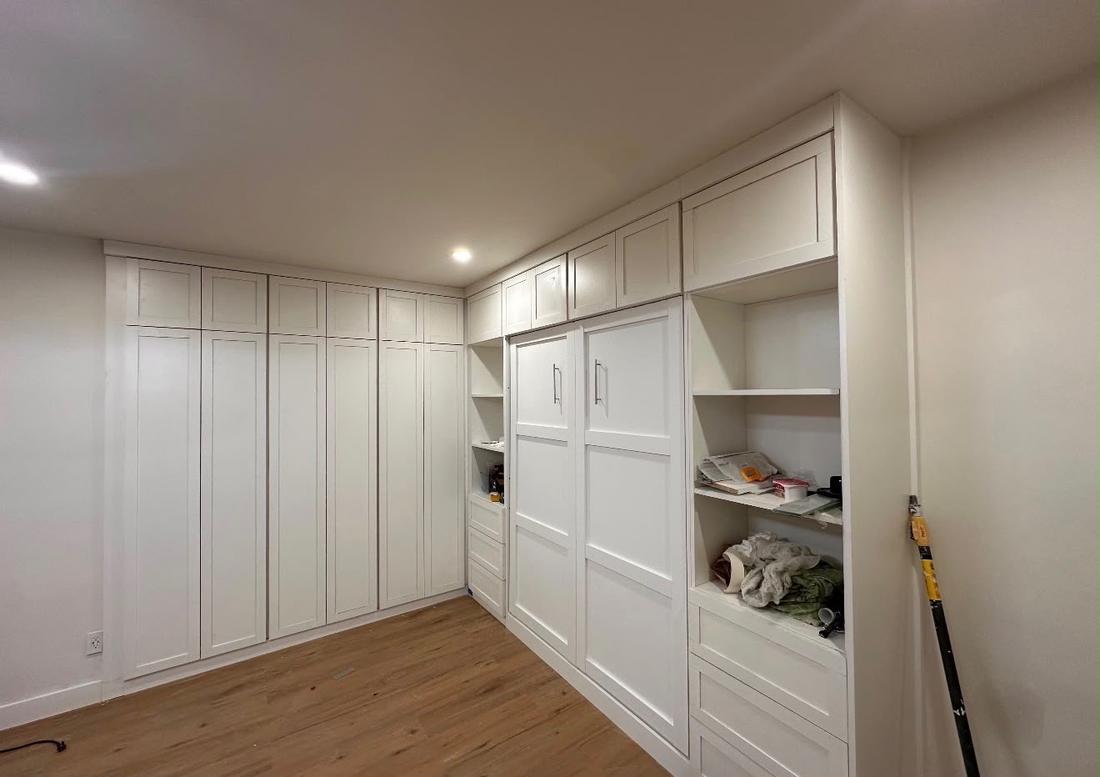 Custom built-in wardrobes with a fold-down wall bed