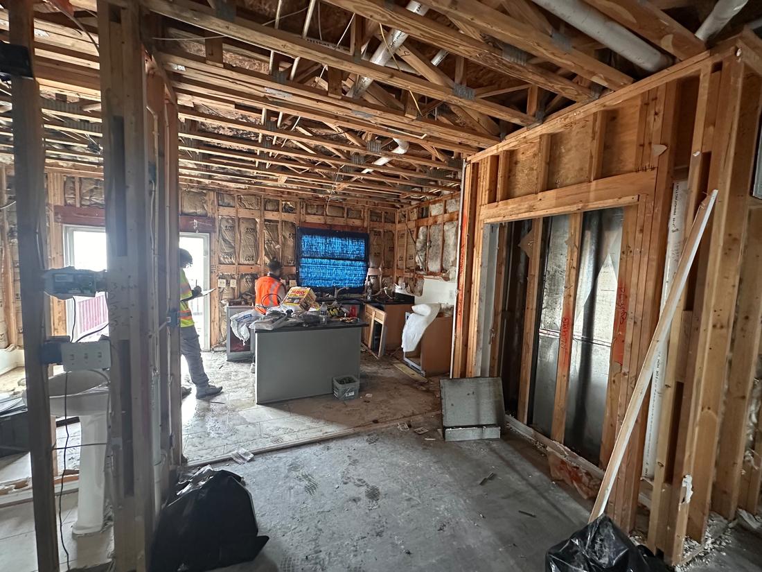 Gutted interior after damage, framing and utilities exposed