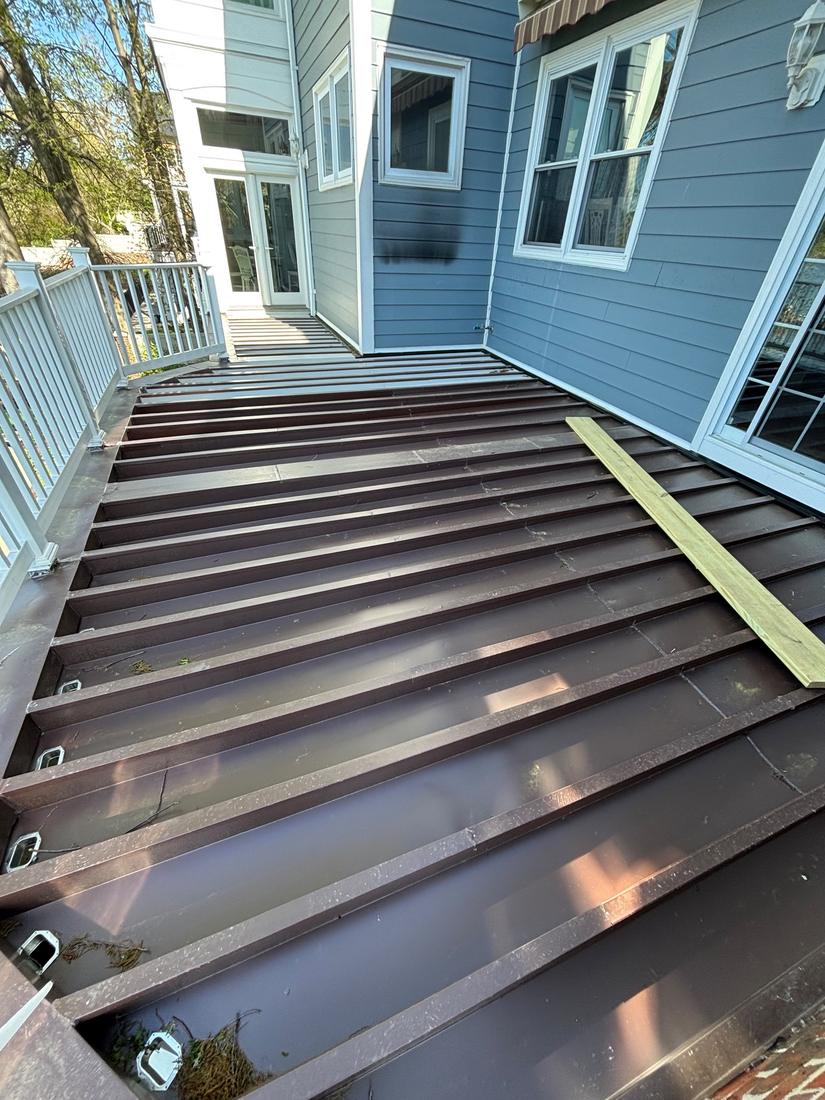 Deck base prep with metal pan and new lumber