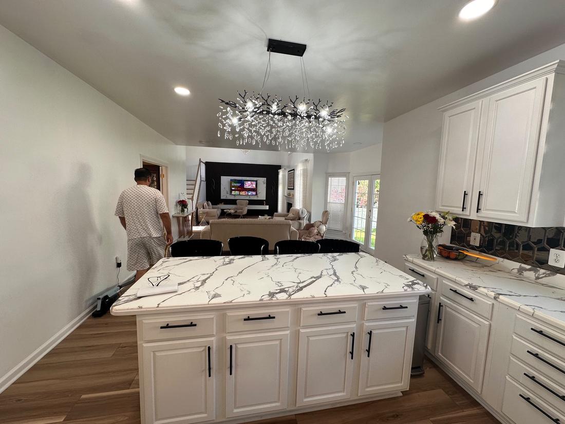 Finished kitchen with island and marble-look countertops