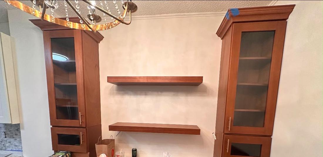 Custom cabinets with glass doors and floating shelves
