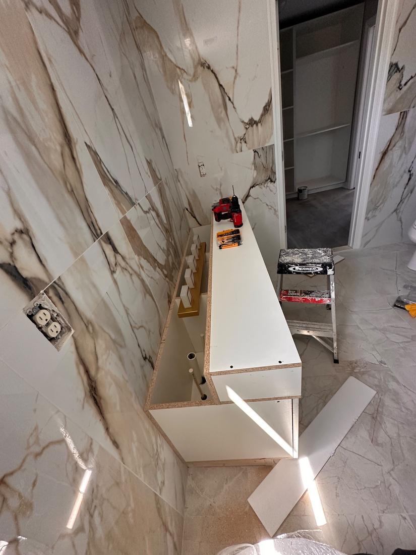Bathroom vanity going in over large-format tile