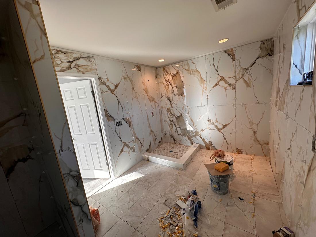Bathroom with large-format tile and a new tiled shower base