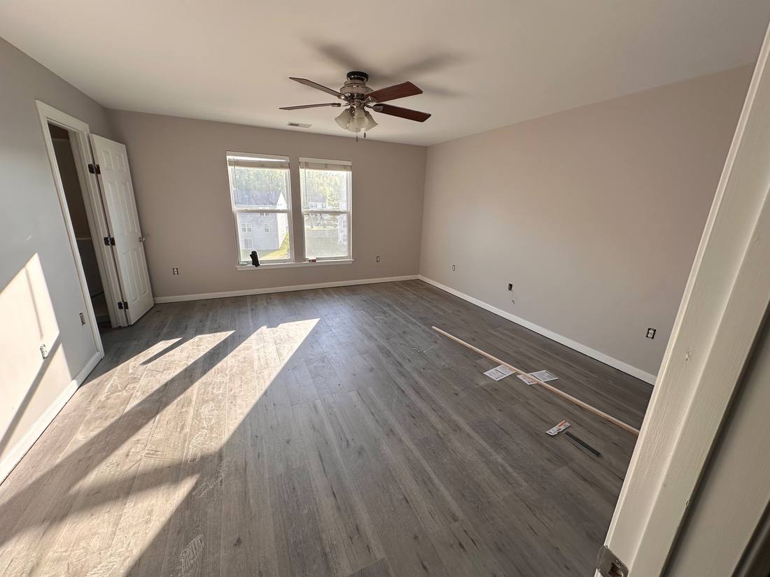 New plank flooring in a freshly painted bedroom