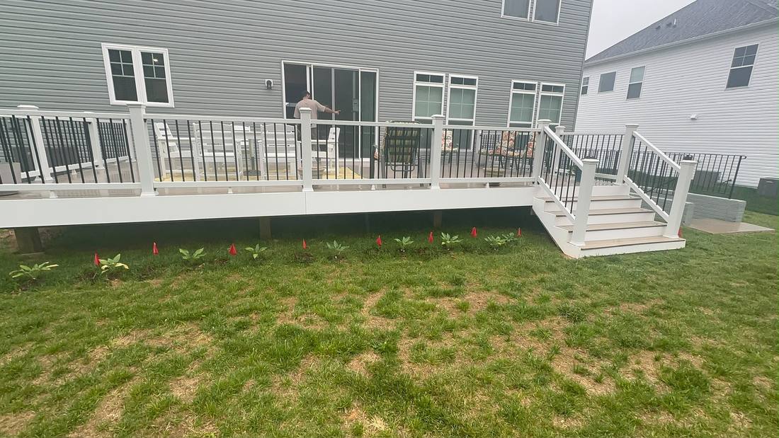 Finished composite deck with white and black railing
