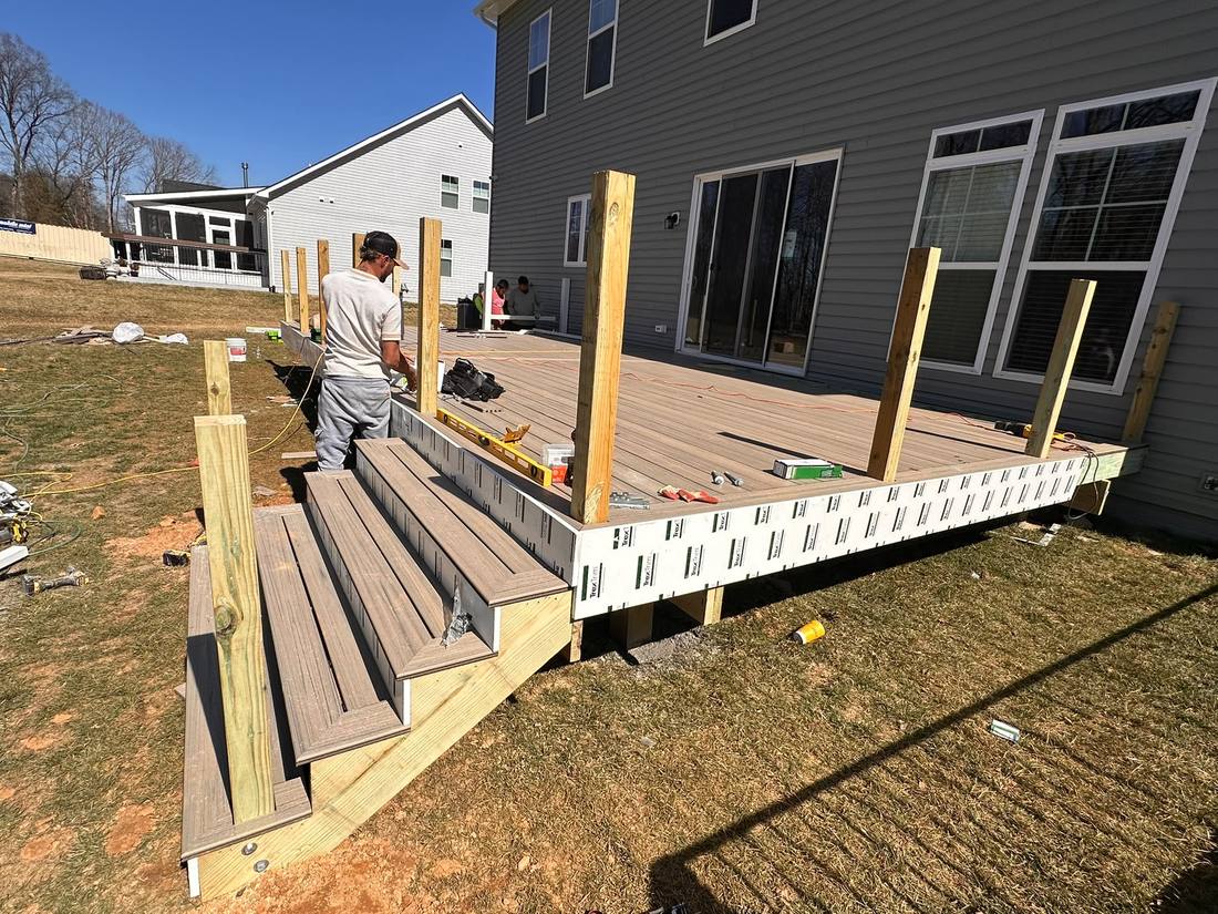 Deck stairs and trim installed, railing posts next